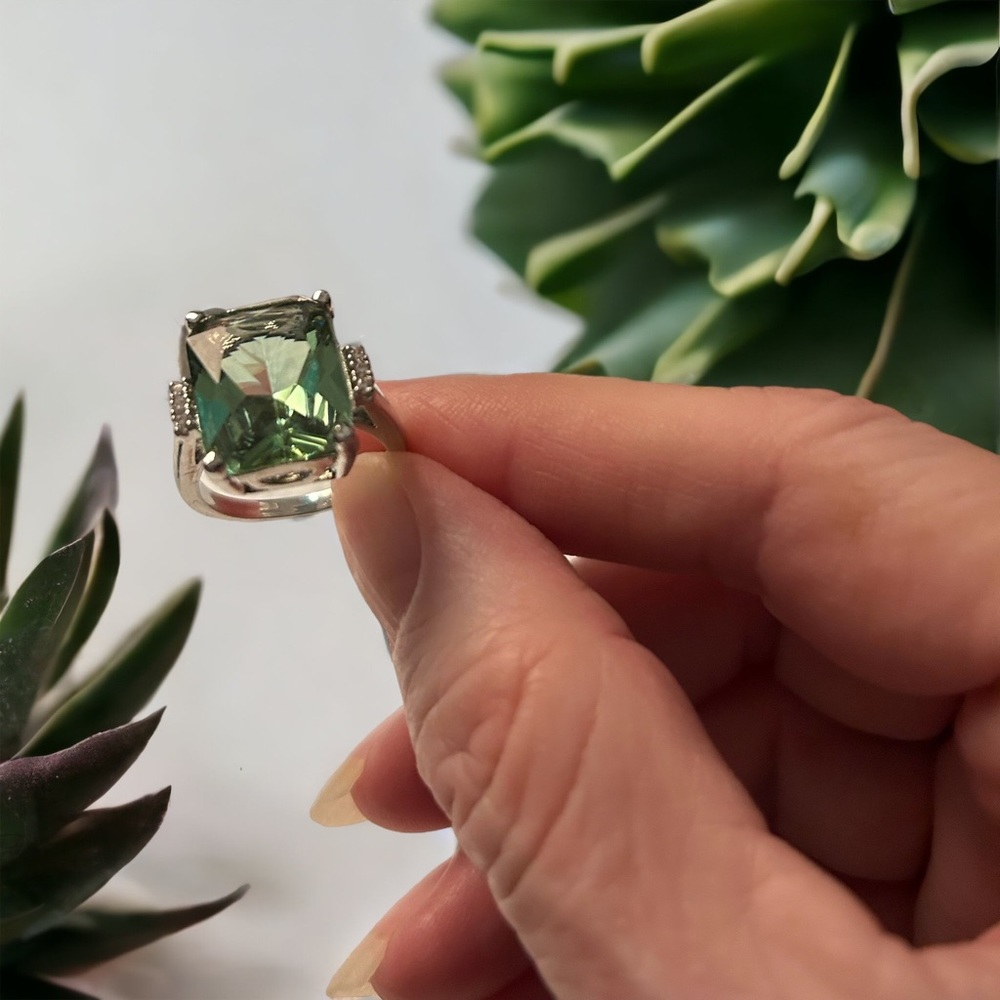 Pale green and silver ring with small rhinestones .